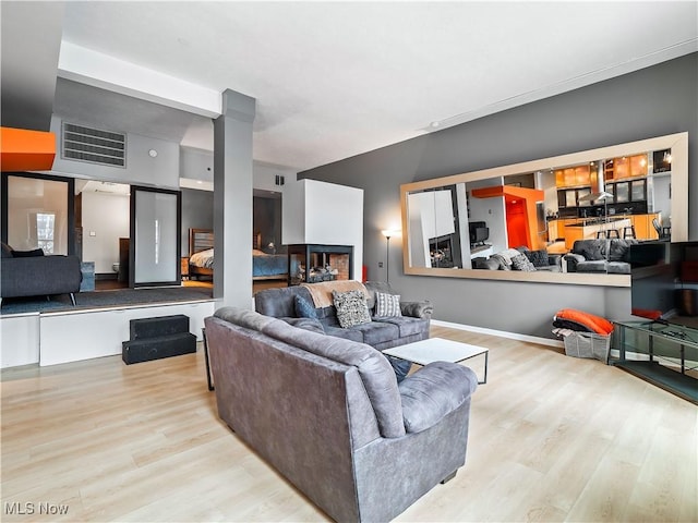 living room featuring visible vents and wood finished floors