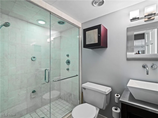 full bathroom featuring toilet, a shower stall, and vanity