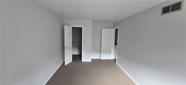 unfurnished bedroom featuring carpet flooring, visible vents, and baseboards