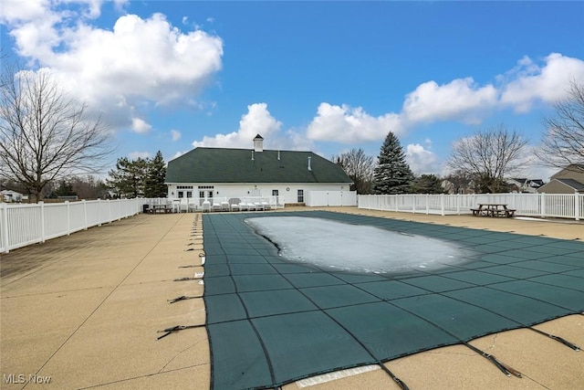 view of swimming pool with a patio area, a fenced backyard, and a fenced in pool