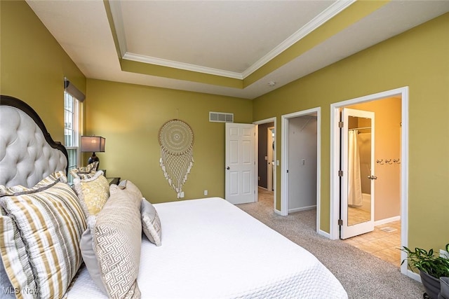 bedroom with baseboards, visible vents, a raised ceiling, light colored carpet, and ornamental molding