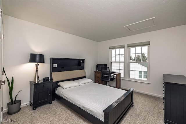 bedroom featuring light carpet, attic access, and baseboards