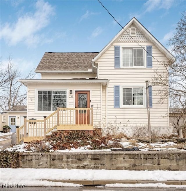 traditional-style home with a shingled roof