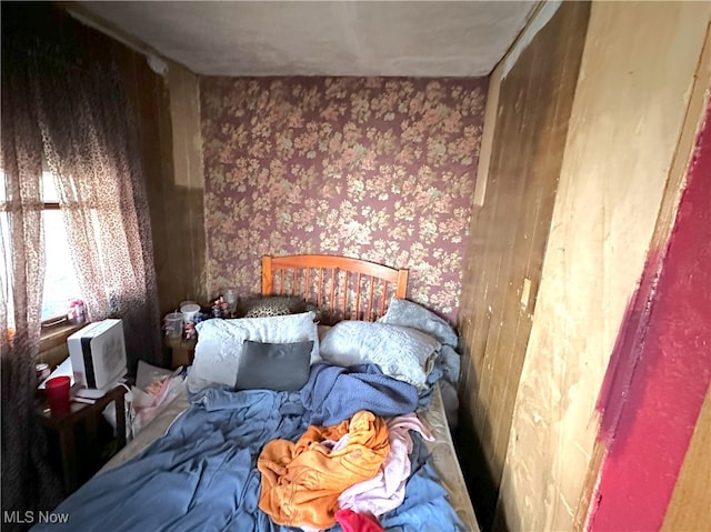 bedroom with wallpapered walls