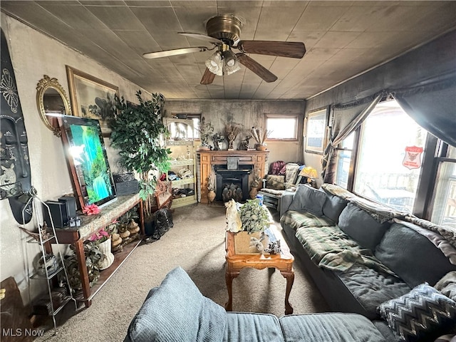 living room with a ceiling fan and carpet