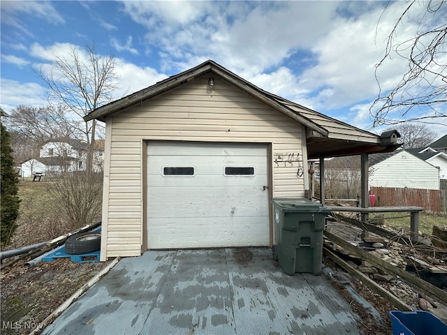 detached garage with driveway and fence