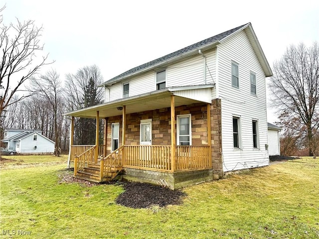 view of front of home with stone siding, a porch, and a front yard