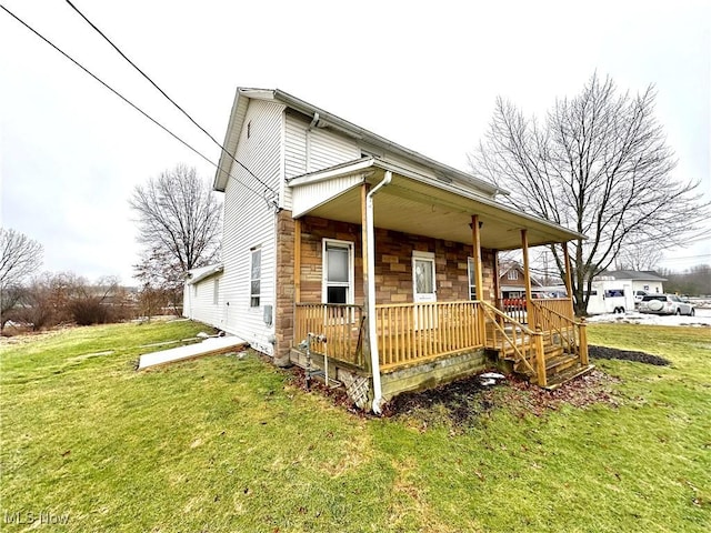 view of property exterior with a porch, stone siding, and a yard