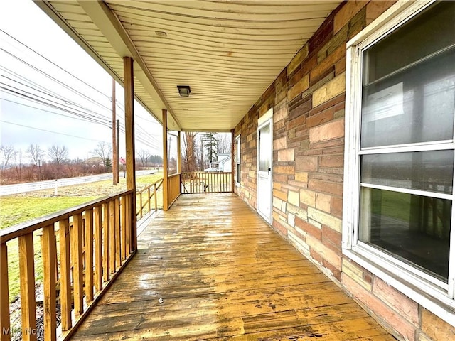 wooden terrace featuring covered porch