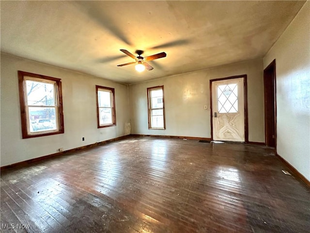 unfurnished room featuring ceiling fan, wood-type flooring, and baseboards