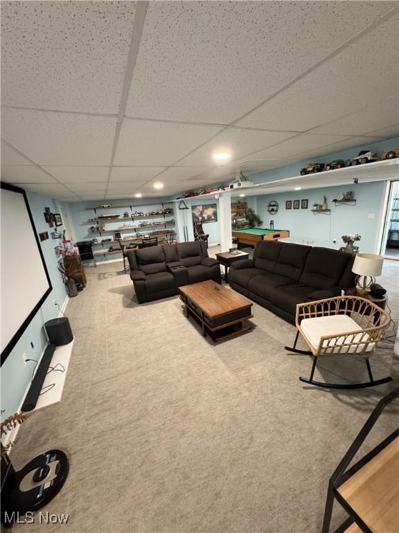 carpeted living room featuring a paneled ceiling