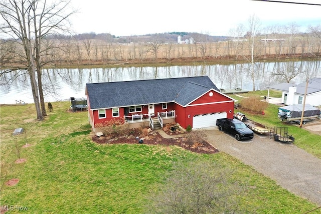 view of front of house with driveway, an attached garage, covered porch, a shingled roof, and a water view