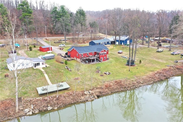 aerial view featuring a wooded view and a water view