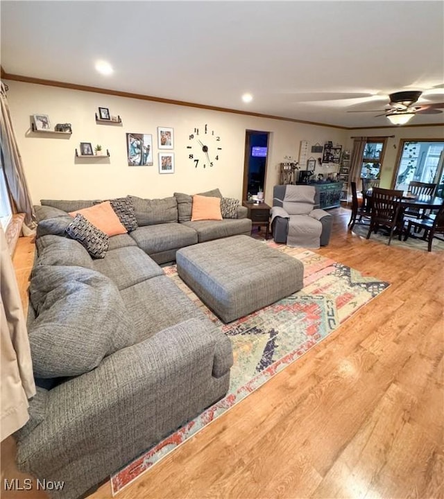 living room featuring ceiling fan, recessed lighting, wood finished floors, and ornamental molding