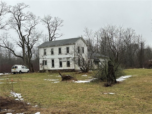 colonial-style house with a front yard