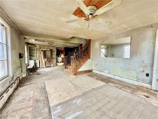 unfurnished room featuring stairs