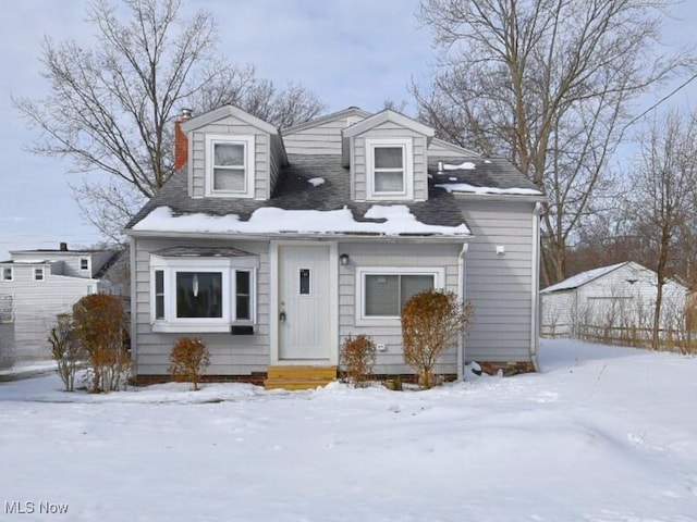 new england style home with a chimney