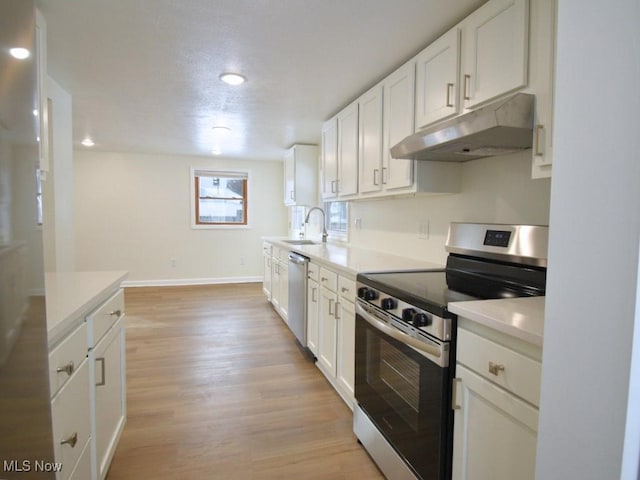 kitchen with stainless steel appliances, light wood-style flooring, white cabinets, and under cabinet range hood