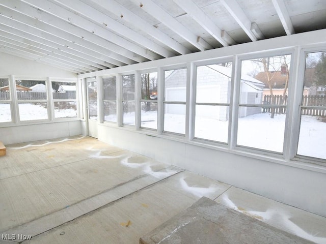 unfurnished sunroom with lofted ceiling