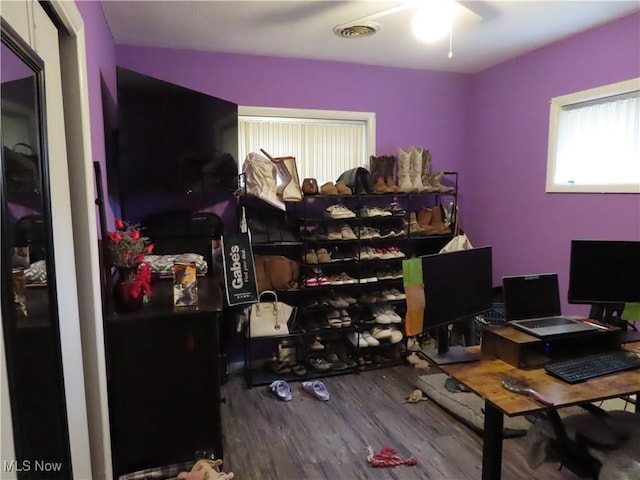 office space with ceiling fan, visible vents, and wood finished floors