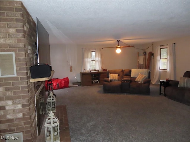 living area featuring a ceiling fan and carpet