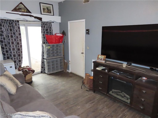 living area with plenty of natural light and wood finished floors