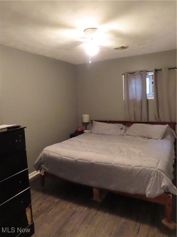 bedroom featuring baseboards and wood finished floors