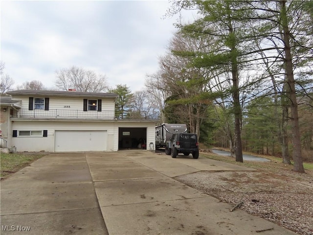 view of home's exterior with an attached garage and driveway