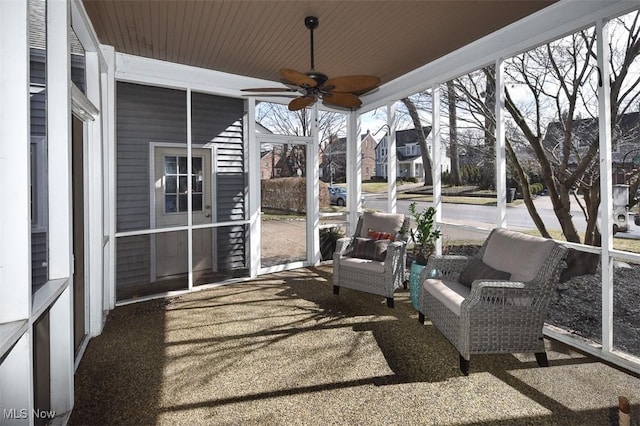 sunroom / solarium featuring wooden ceiling and a ceiling fan