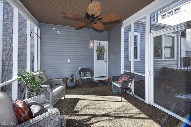 sunroom / solarium featuring wood ceiling and ceiling fan