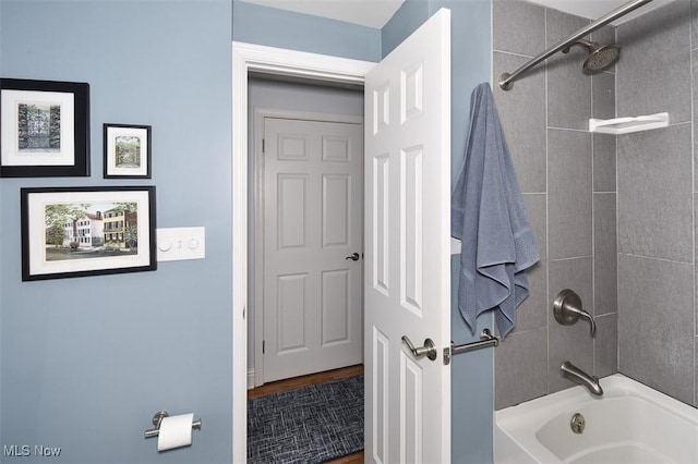 bathroom with bathing tub / shower combination