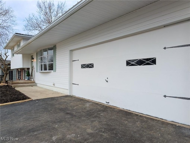 exterior space with a garage and covered porch