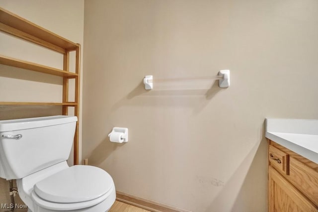 bathroom featuring toilet and vanity