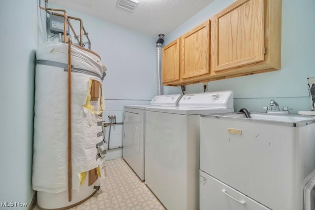 laundry area featuring light floors, cabinet space, visible vents, a sink, and washer and dryer