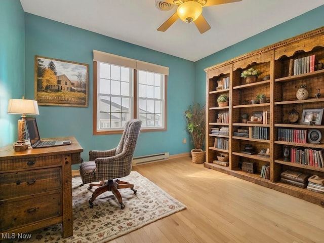 office space with baseboards, ceiling fan, a baseboard heating unit, and wood finished floors