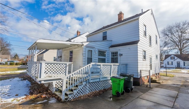 back of property with a chimney