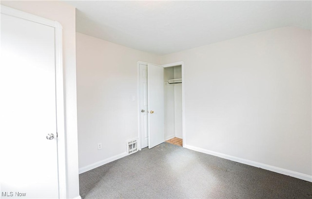 unfurnished bedroom featuring baseboards, visible vents, and a closet