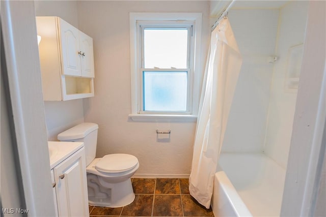 bathroom featuring shower / bath combination with curtain, vanity, toilet, and baseboards