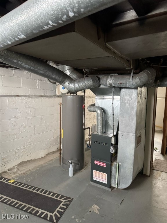 utility room with heating unit and water heater