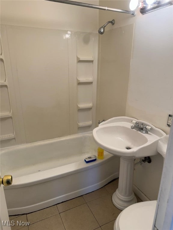 bathroom featuring toilet, shower / bathtub combination, and tile patterned floors