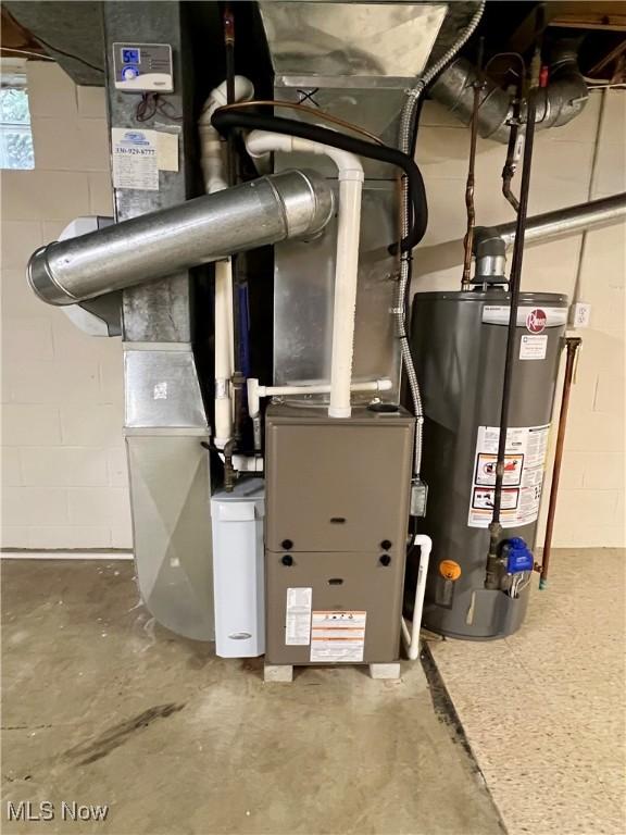 utility room featuring gas water heater