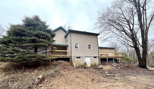 view of side of home featuring a wooden deck