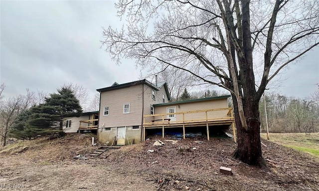 rear view of house with a wooden deck