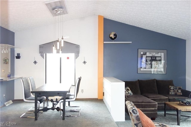 dining room with lofted ceiling, carpet, baseboards, and a textured ceiling