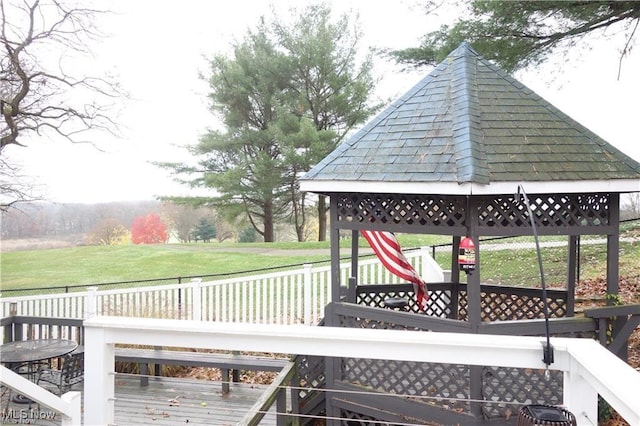 wooden terrace with a lawn and a gazebo