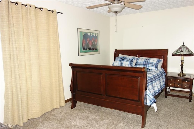 bedroom featuring carpet floors, ceiling fan, and a textured ceiling