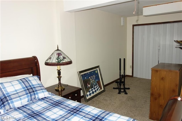 bedroom with carpet flooring and baseboards