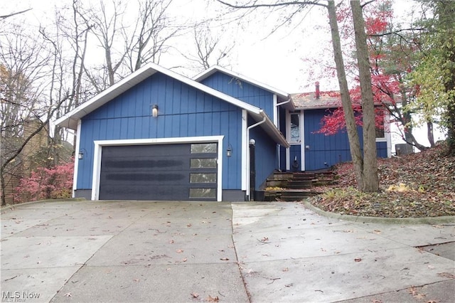 view of front of property featuring concrete driveway and an attached garage