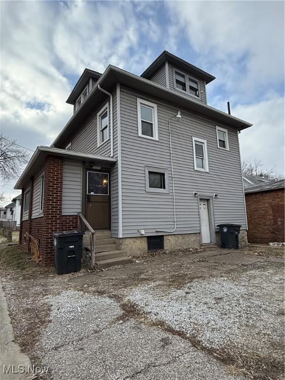 back of house with entry steps