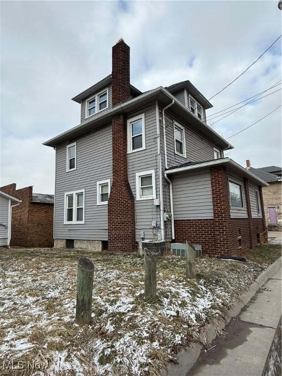 view of side of home with a chimney